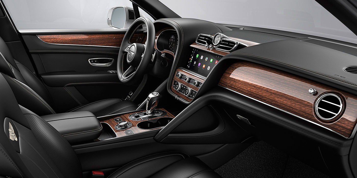 Bentley Manila Bentley Bentayga interior with a Crown Cut Walnut veneer, view from the passenger seat over looking the driver's seat.
