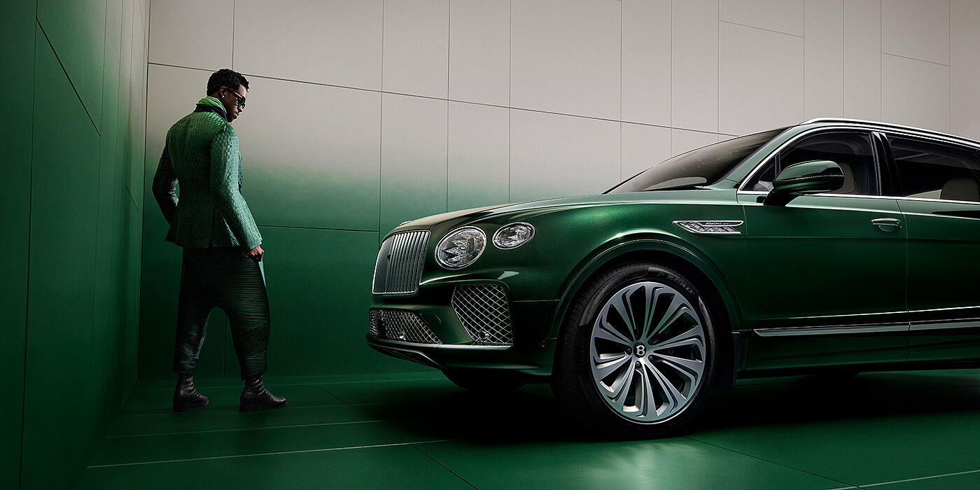 Bentley Manila Wisdom K standing next to Bentley Bentayga Extended Wheelbase SUV in Light Emerald green paint in profile
