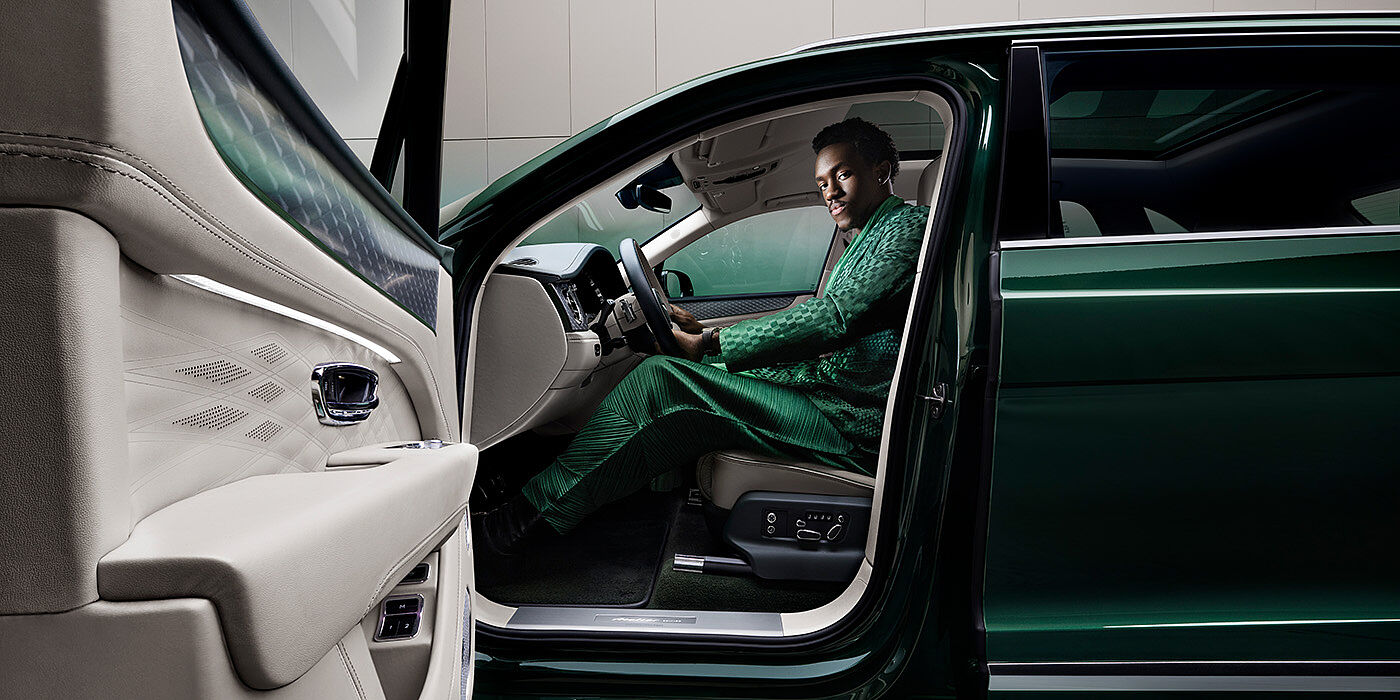 Bentley Manila Wisdom K seated in Bentley Bentayga Extended Wheelbase SUV in Light Emerald green paint with door open