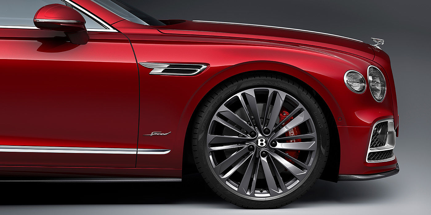 Bentley Manila Bentley Flying Spur Speed sedan front wheel in close up with Dragon Red II paint