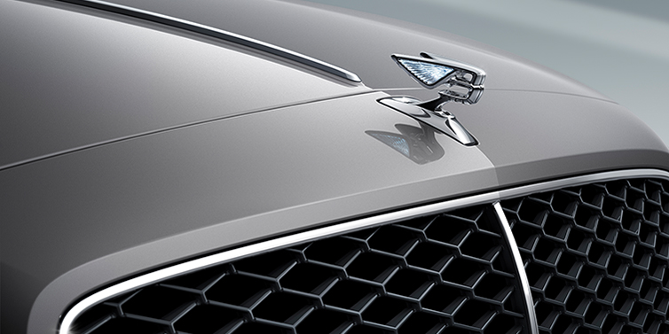 Bentley Manila New Bentley Flying Spur sedan bonnet detail in Silverlake paint with Illuminated Flying B bonnet badge and matrix grille with chrome surround