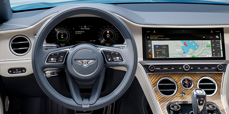 Bentley Manila New Bentley Continental GT Azure coupe front interior in Linen and Brunel blue hides, showing steering wheel and driver's instruments